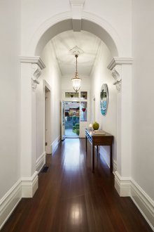Diseño de pasillo con arco y moldura de estuco.