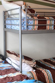 Metal bed in a nursery for three