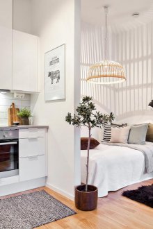 The bedroom in the studio apartment is white