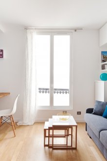 Bedroom in a studio apartment with a sofa