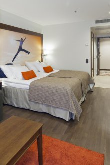 The bedroom in the studio apartment is orange
