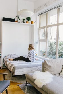Bedroom in a studio apartment with a panoramic window