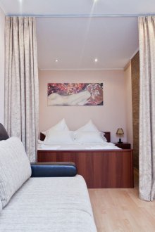 Bedroom in a studio apartment with curtains