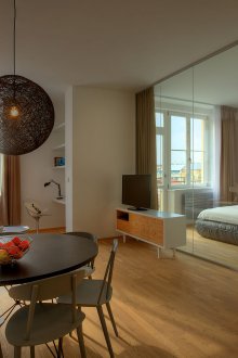 Bedroom in a studio apartment with glass partitions