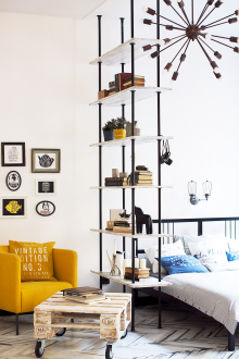 Bedroom in a studio apartment with shelving