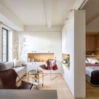 Bedroom in a studio apartment with a wall partition