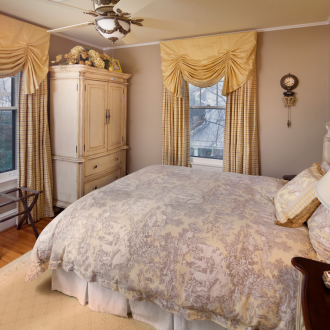 Beige curtains with lambrequins in the bedroom