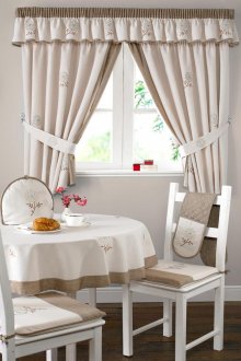 Window decoration with cream curtains with a lambrequin in the kitchen