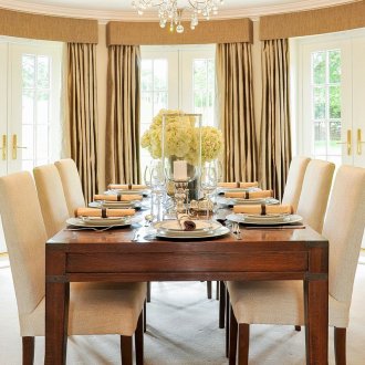 Window decoration with beige curtains with lambrequins in the dining room