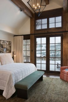 Chambre de style chalet avec cheminée et balcon