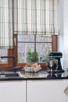 Elegant striped roman curtains in the kitchen